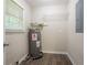 A utility room with vinyl flooring featuring a water heater and wire shelving at 1496 Indian Forest Ct, Stone Mountain, GA 30083