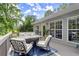 Spacious back deck with outdoor seating and table offering views of the trees and clear blue sky at 2730 Samples Rd, Cumming, GA 30041