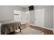 Cozy bedroom boasts wood floors with an ensuite bathroom and tv on the wall at 2730 Samples Rd, Cumming, GA 30041