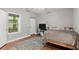 Cozy bedroom with wood-look floors and a large window at 2730 Samples Rd, Cumming, GA 30041