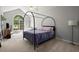Primary bedroom with a black four poster bed and lots of natural light from a large window at 2730 Samples Rd, Cumming, GA 30041