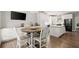 Bright kitchen dining area with a wooden table and stainless steel appliances at 2730 Samples Rd, Cumming, GA 30041