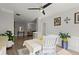 Bright dining room with seating, ceiling fan and views to living space at 2730 Samples Rd, Cumming, GA 30041