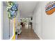Inviting entryway with hardwood floors, adorned with a blue floral wreath and a glimpse into the living room at 2730 Samples Rd, Cumming, GA 30041