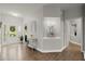 Inviting entryway with hardwood floors, adorned with plants and a glimpse of the front door at 2730 Samples Rd, Cumming, GA 30041