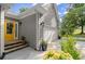 Front exterior featuring a yellow door, attached garage, and some well manicured bushes at 2730 Samples Rd, Cumming, GA 30041