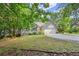 Charming one-story home with a gray exterior, attached garage, manicured lawn, and bright yellow front door, surrounded by trees at 2730 Samples Rd, Cumming, GA 30041