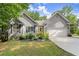 Charming single-Gathering home with a well-manicured lawn, complemented by a yellow door and attached garage at 2730 Samples Rd, Cumming, GA 30041