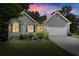 Charming home featuring a well-maintained yard, inviting front porch, and attached garage at 2730 Samples Rd, Cumming, GA 30041