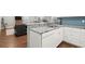 Open kitchen with granite countertops, white cabinets, and a large sink at 2730 Samples Rd, Cumming, GA 30041