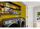 Functional laundry room with modern washer, dryer, shelves, and storage at 2730 Samples Rd, Cumming, GA 30041