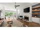 Bright living room with large windows, fireplace, and hardwood flooring at 2730 Samples Rd, Cumming, GA 30041