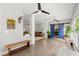 Spacious living room featuring hardwood floors, ample seating, modern ceiling fans, and barn doors to the main bedroom at 2730 Samples Rd, Cumming, GA 30041