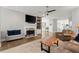 Cozy living room with a fireplace, ceiling fan, and hardwood flooring at 2730 Samples Rd, Cumming, GA 30041
