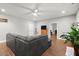 Bright living room features a ceiling fan, hardwood floors, and a comfortable sectional sofa at 2730 Samples Rd, Cumming, GA 30041