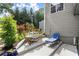Cozy patio with table, chairs, and a lounge chair surrounded by lush greenery at 2730 Samples Rd, Cumming, GA 30041