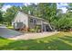 Rear exterior view of home with a large driveway, yard, deck, patio, landscaping, and a gazebo at 2730 Samples Rd, Cumming, GA 30041