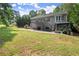The home features a deck, patio, hot tub, and gazebo in the expansive backyard and lawn at 2730 Samples Rd, Cumming, GA 30041