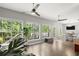 Inviting sunroom filled with natural light from large windows, and hardwood flooring at 2730 Samples Rd, Cumming, GA 30041