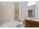 A white shower-tub combo, toilet, and sink vanity with tiled backsplash at 4742 Legacy Cove Ln, Smyrna, GA 30126