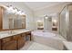 Bright bathroom features a double sink vanity, a soaking tub, and a glass enclosed shower at 4742 Legacy Cove Ln, Smyrna, GA 30126