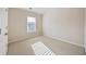 This bedroom features a neutral carpet, a double-hung window, and a white door at 4742 Legacy Cove Ln, Smyrna, GA 30126