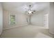Primary bedroom with ceiling fan, plush carpeting, and natural light at 4742 Legacy Cove Ln, Smyrna, GA 30126