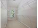 Walk-in closet with carpeted floor and white shelving along the walls and near the window at 4742 Legacy Cove Ln, Smyrna, GA 30126
