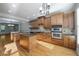 Kitchen with kitchen island, wooden cabinets, stainless steel double oven, and granite countertops at 4742 Legacy Cove Ln, Smyrna, GA 30126
