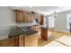 Kitchen with granite countertop, wooden cabinets, kitchen island, and stainless sink at 4742 Legacy Cove Ln, Smyrna, GA 30126