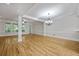 Bright living room featuring hardwood floors, large windows, and elegant chandelier at 4742 Legacy Cove Ln, Smyrna, GA 30126