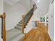Staircase with oak handrail, carpeted steps, and black wrought iron balusters at 4742 Legacy Cove Ln, Smyrna, GA 30126