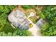 Overhead view of home with a large yard, deck, fire pit, and a long driveway in a lush green surrounding at 627 Apache Trl, Woodstock, GA 30189