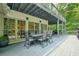 Spacious back deck with outdoor dining area overlooking a wooded backyard at 627 Apache Trl, Woodstock, GA 30189