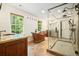 Elegant bathroom with a standalone tub, walk-in shower, and granite counters at 627 Apache Trl, Woodstock, GA 30189