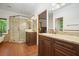 Bright bathroom featuring double sinks, granite counters, a glass shower and a clawfoot tub at 627 Apache Trl, Woodstock, GA 30189