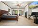 Cozy bedroom featuring a fireplace, TV, and backyard access through glass doors at 627 Apache Trl, Woodstock, GA 30189