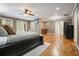 Spacious main bedroom with hardwood floors, ceiling fan, ensuite bathroom and access to the outside via French doors at 627 Apache Trl, Woodstock, GA 30189