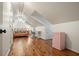 Spacious bonus room with hardwood floors, a pink sofa and a retro pink mini refrigerator, perfect for relaxing and entertaining at 627 Apache Trl, Woodstock, GA 30189
