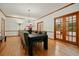 Elegant dining room with hardwood floors, chandelier, and wood-framed glass doors at 627 Apache Trl, Woodstock, GA 30189