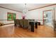 Dining area featuring a modern chandelier, hardwood floors, and neutral decor at 627 Apache Trl, Woodstock, GA 30189