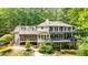 Beautiful house features multiple decks and large screened porch overlooking a lush green landscape at 627 Apache Trl, Woodstock, GA 30189