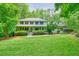 Traditional two-story home with mature trees and green grass at 627 Apache Trl, Woodstock, GA 30189