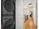 Hallway with stacked washer and dryer that leads to a bright living area at 627 Apache Trl, Woodstock, GA 30189