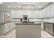 Well-appointed kitchen with island, white cabinets, granite countertops, and stainless steel appliances at 627 Apache Trl, Woodstock, GA 30189