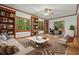 Inviting living room with hardwood floors, built-in bookshelves, and natural light at 627 Apache Trl, Woodstock, GA 30189