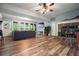 Spacious living room with hardwood floors, a cozy fireplace, a TV, and lots of natural light from the windows at 627 Apache Trl, Woodstock, GA 30189