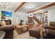 Comfortable living room showcasing a stone fireplace, staircase, and stylish decor elements at 627 Apache Trl, Woodstock, GA 30189