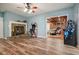 Cozy living room featuring hardwood floors, a stone fireplace, vintage arcade games and access to the basement at 627 Apache Trl, Woodstock, GA 30189