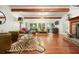 Inviting living room with hardwood floors, exposed beams, fireplace, and abundant natural light at 627 Apache Trl, Woodstock, GA 30189